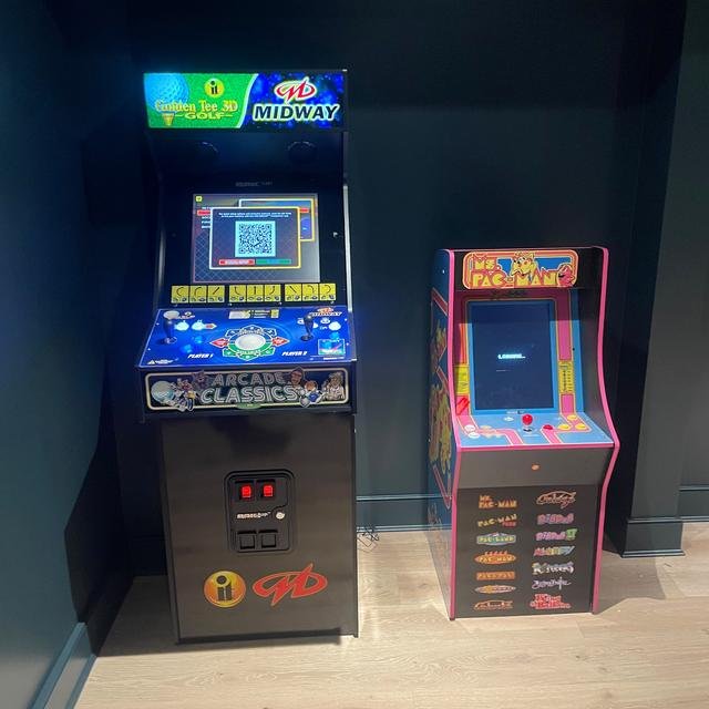 Two arcade cabinets set up in a game room